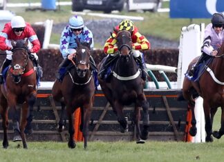 Anna Bunina (blue silks) wins the Coral Scottish Champion Hurdle